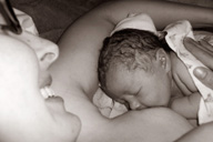 photo of mother breastfeeding newborn baby